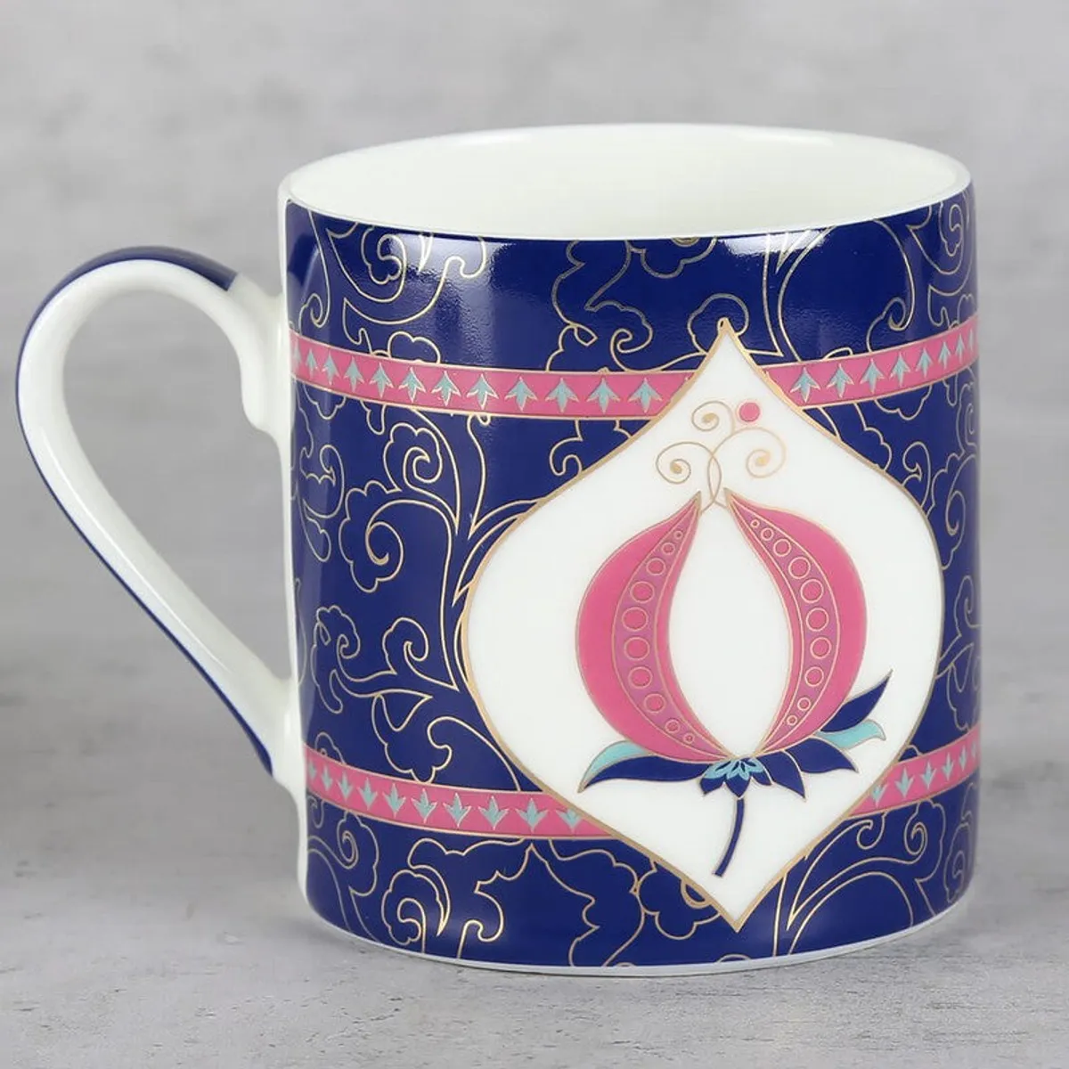 Close-up of a blue bone china mug with pink motif and glossy finish