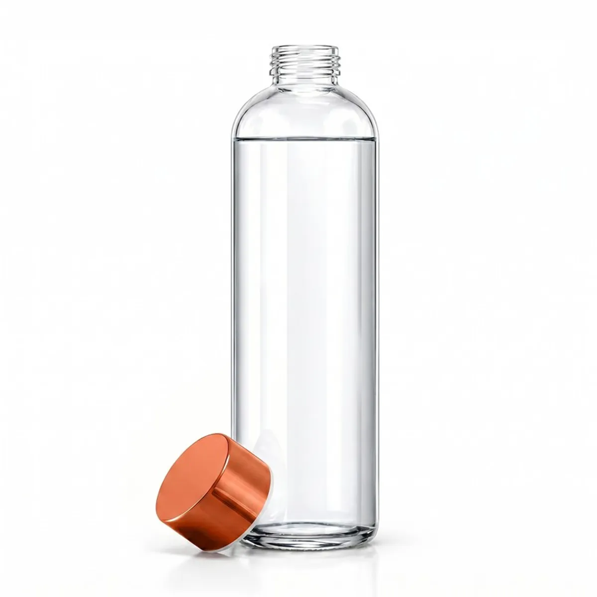Clear glass water bottle with its metallic gold cap placed beside it