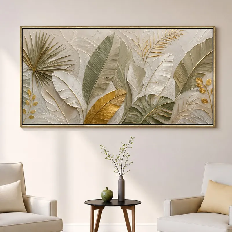 Wide framed leaf artwork displayed on a light wall between armchairs