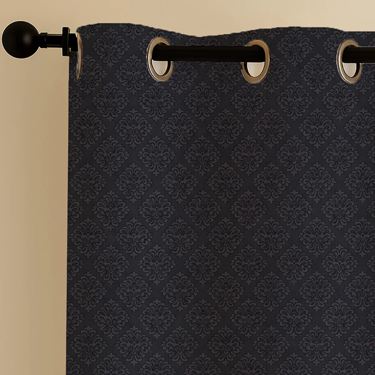 Close-up of black curtain with tonal motif and eyelet top