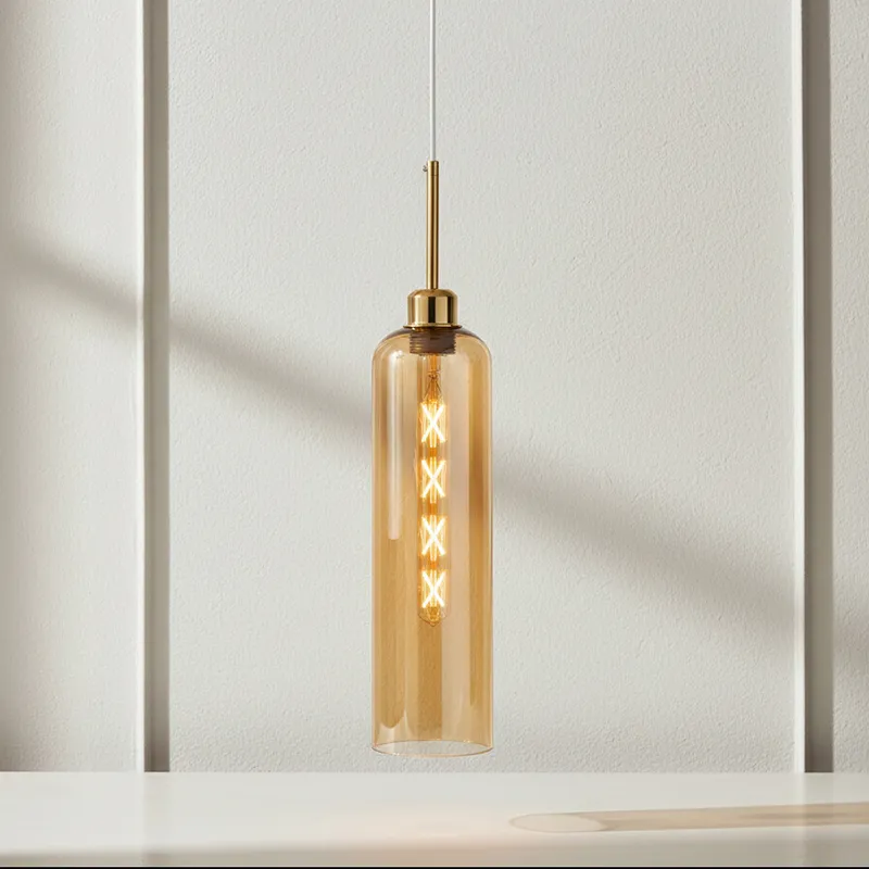 Amber glass cylindrical pendant lamp with gold-toned metal fitting