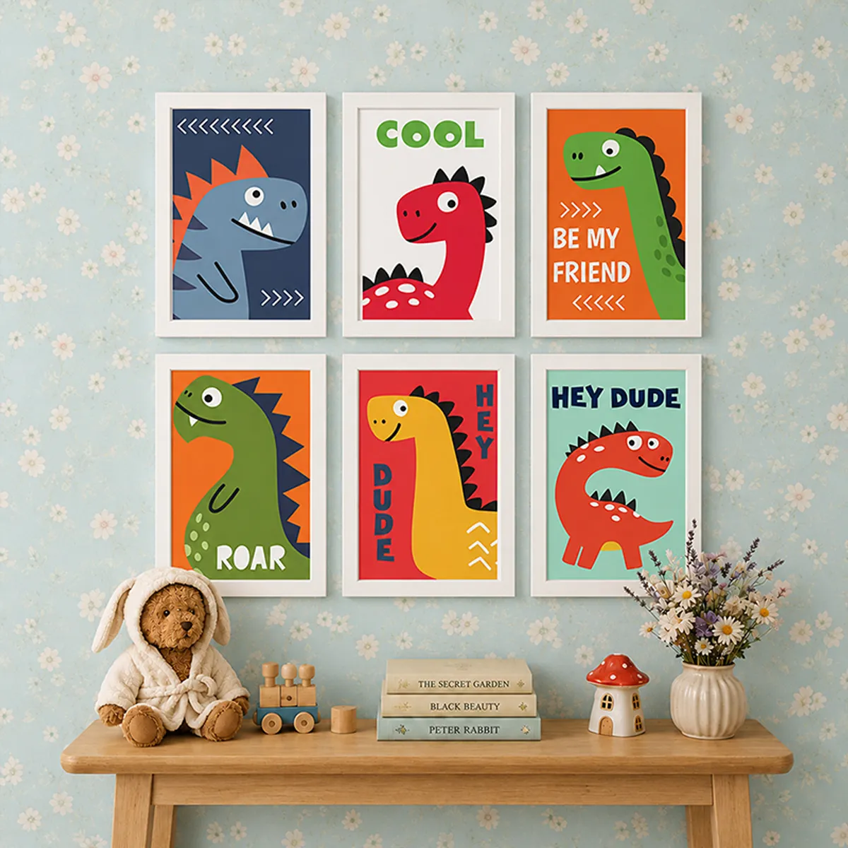 Six framed dinosaur art prints above a wooden table with books, teddy and flowers