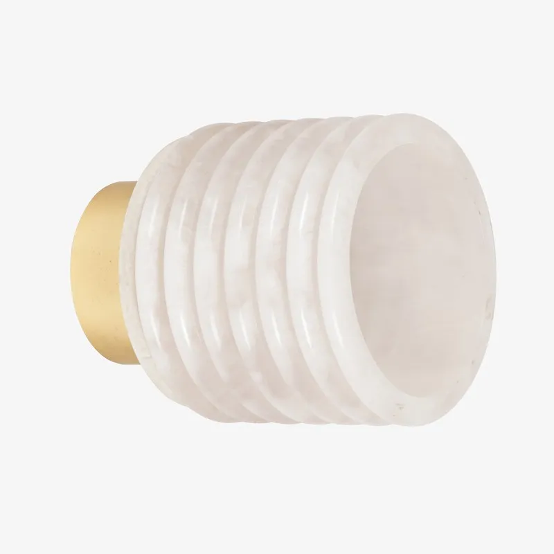 Front angled view of ivory ribbed resin wall lamp with gold-toned base