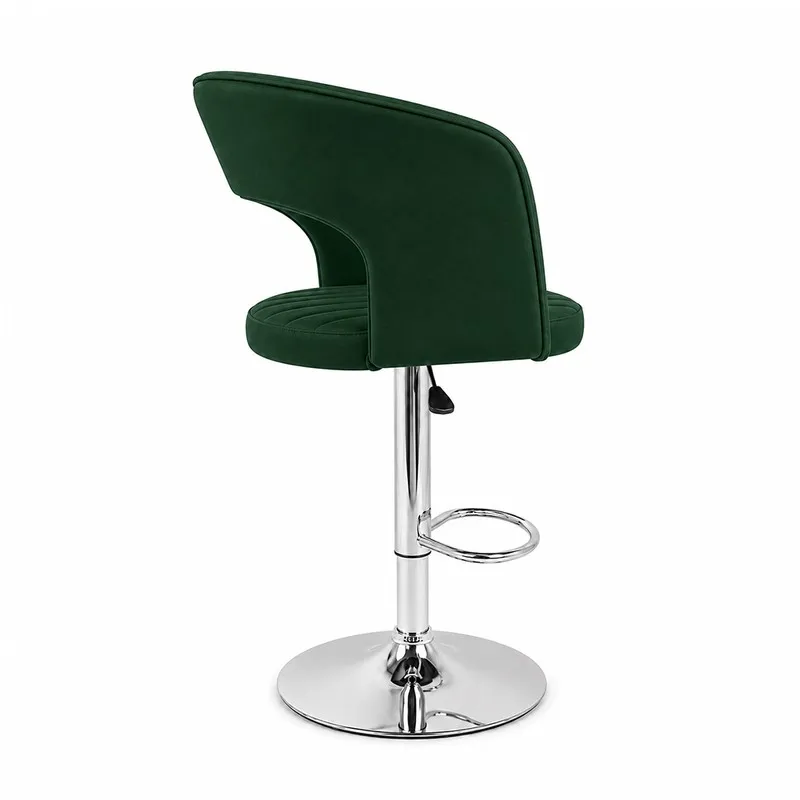 Rear side view of green velvet bar chair with curved back and chrome base