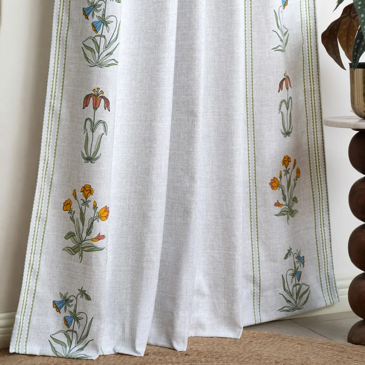Close view of white curtain with vertical floral border design