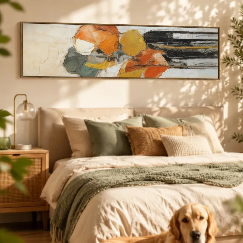 Rectangular abstract framed canvas wall art in warm tones above a bed