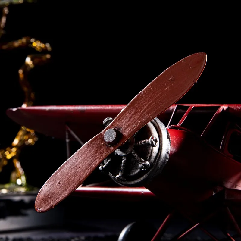 Close-up of the front propeller on the red aeroplane showpiece