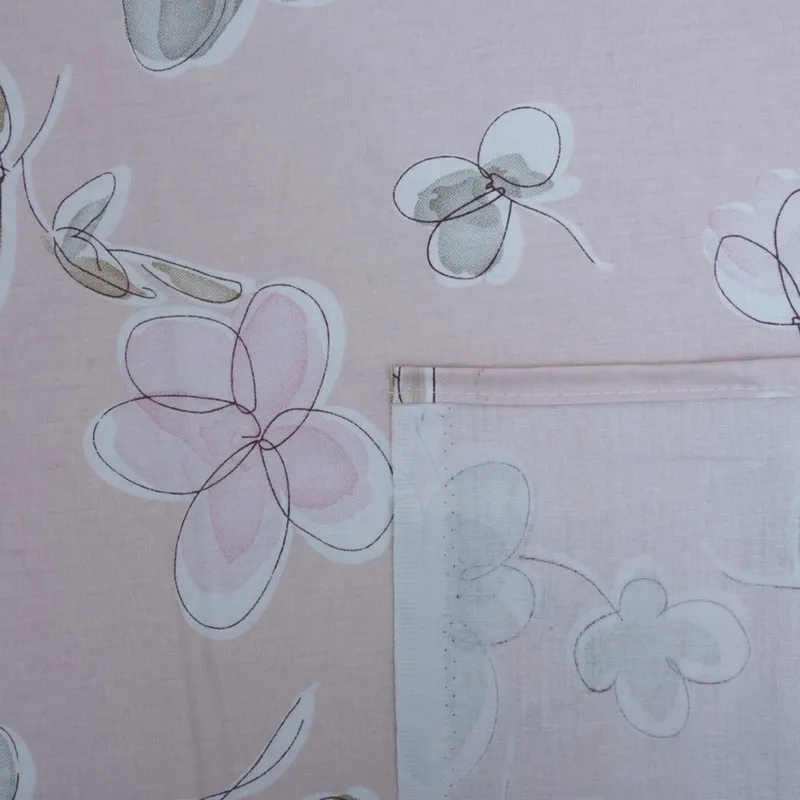 Close-up of pink floral print and stitched edge detail