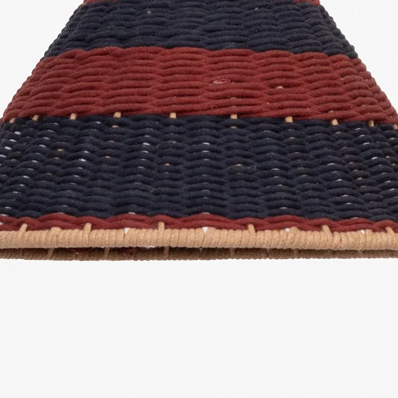 Close-up of the textured red, black and natural edge of the lamp shade