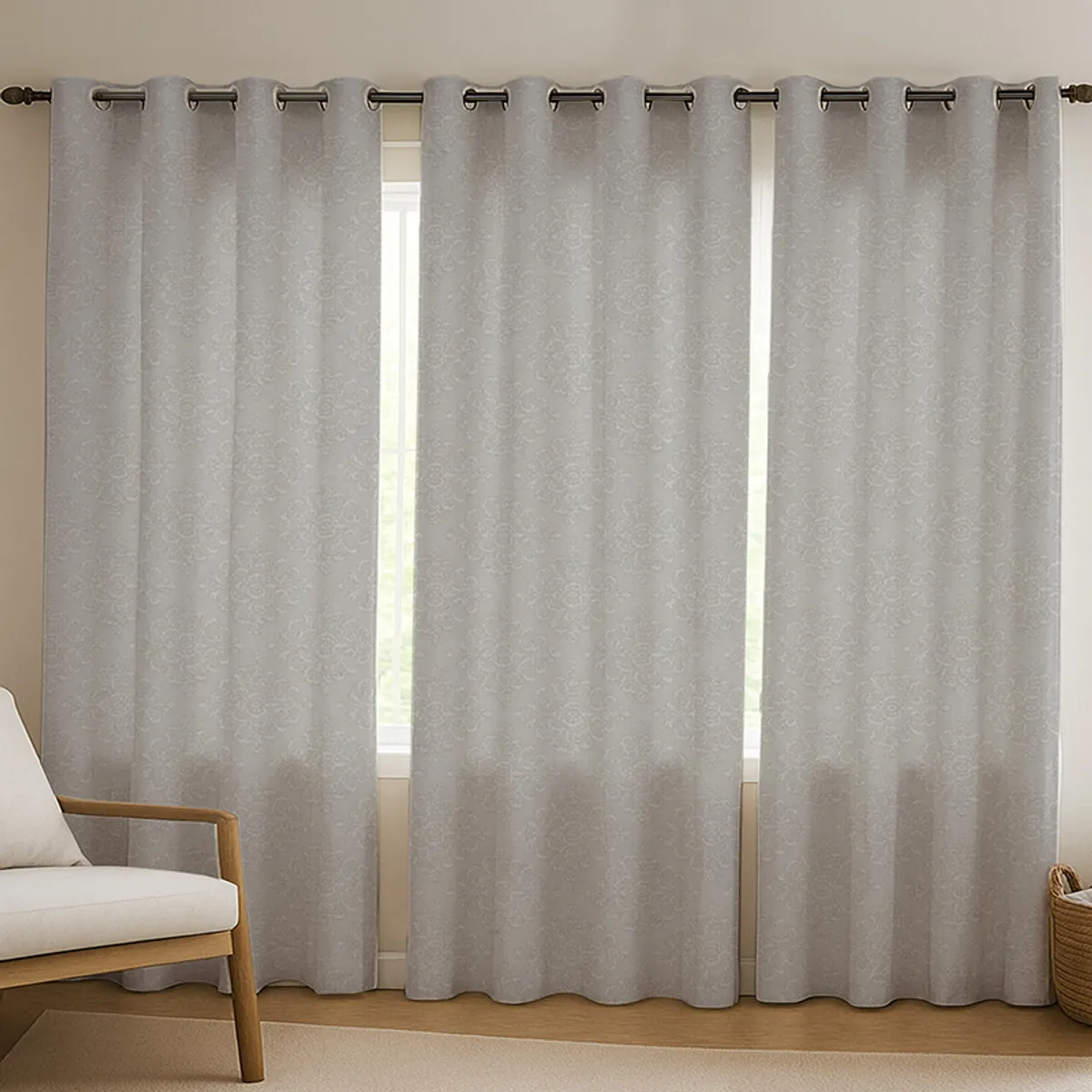 Grey patterned curtains hanging across a window in a living room