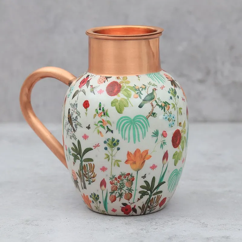 Copper jug with a curved handle and colourful floral artwork