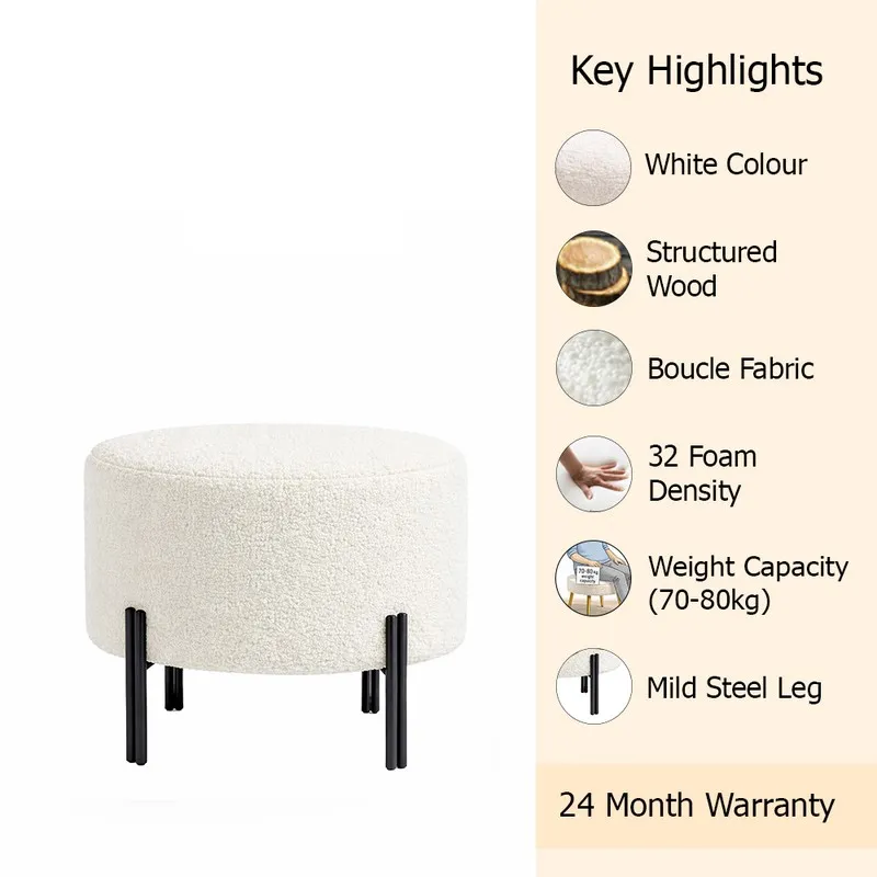 Off-white round ottoman shown in a styled room with black legs