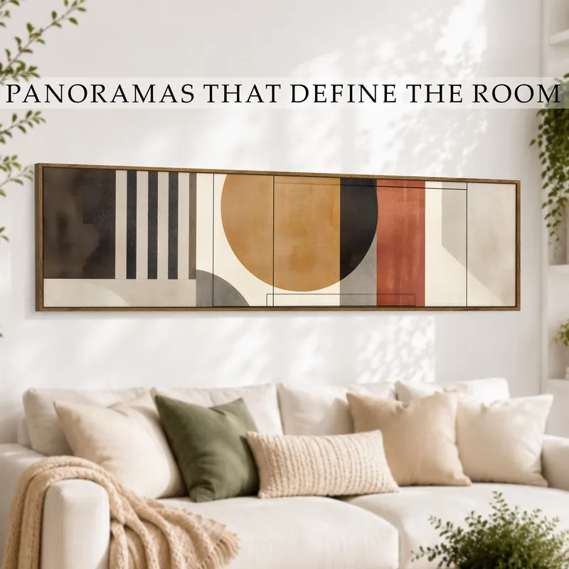 Panoramic framed wall art displayed above a cream sofa in a bright living room