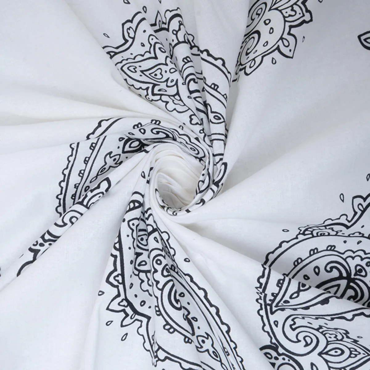 Close-up of white cotton fabric with black paisley pattern