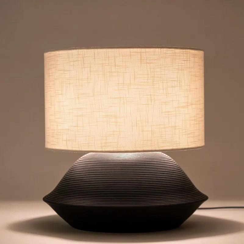 Front view of black table lamp with beige cylindrical shade