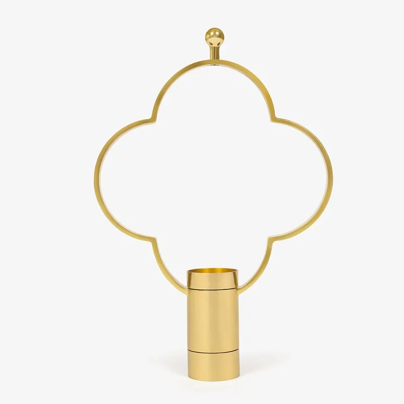 Front view of a gold stainless steel candle holder with clover-shaped arch