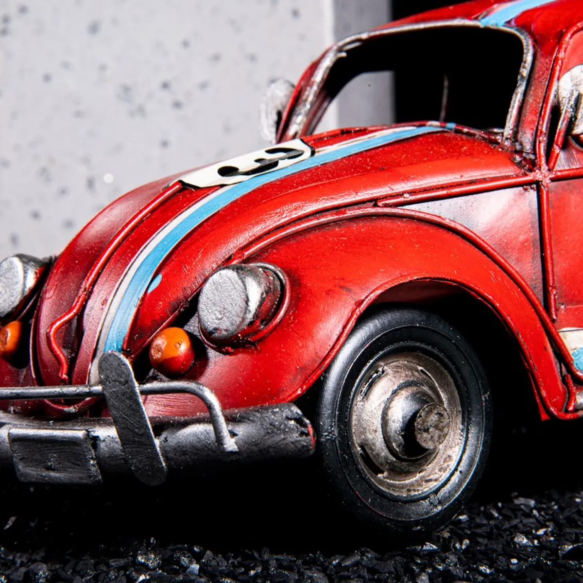 Close-up of the front wheel and headlight detailing on the red car showpiece