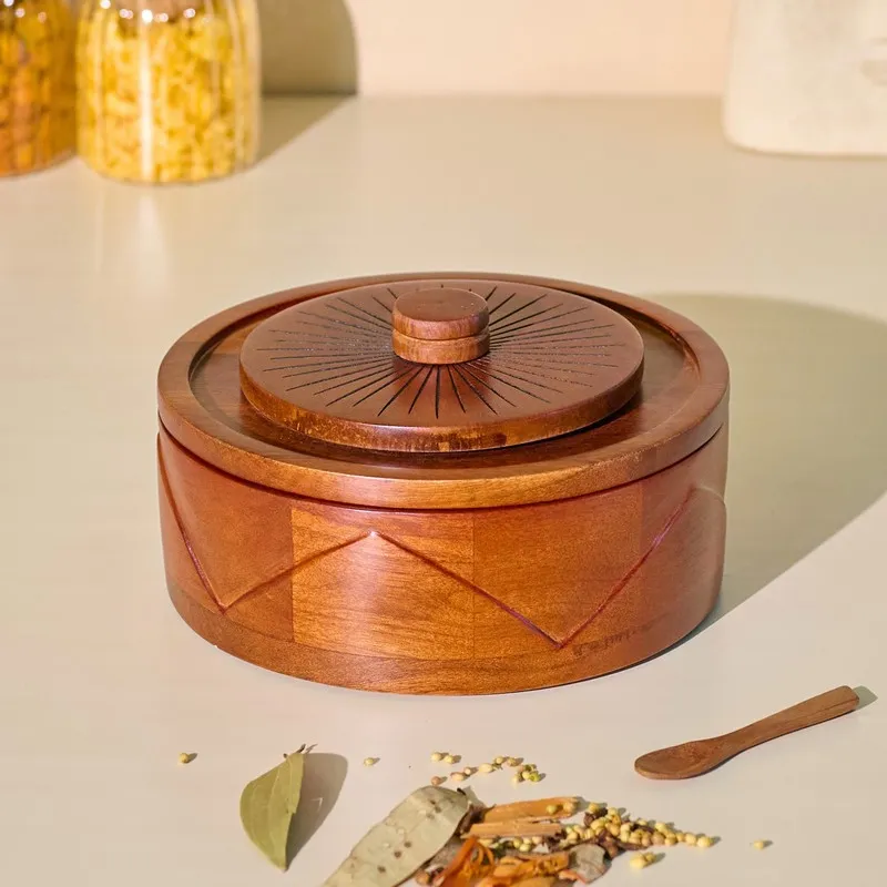 Closed brown round wooden masala box with glossy finish and sunburst lid
