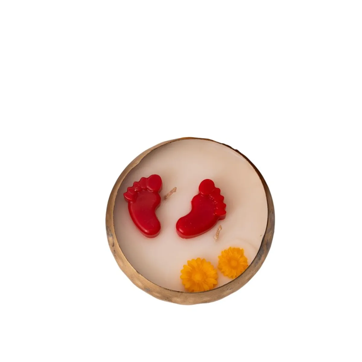 Top-down product view of a round candle with red footsteps and yellow flowers.