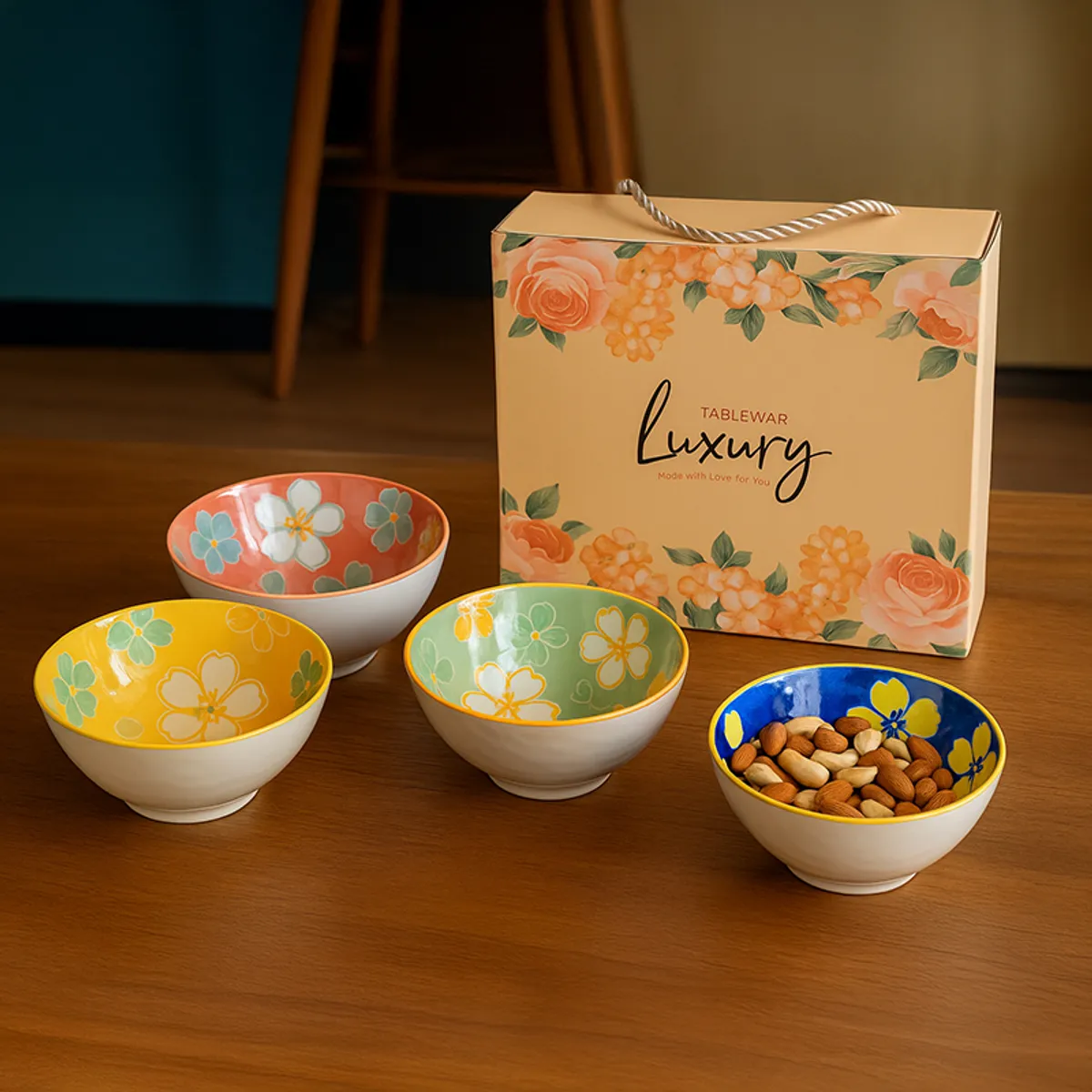 Four colourful floral bowls beside a decorative tableware box