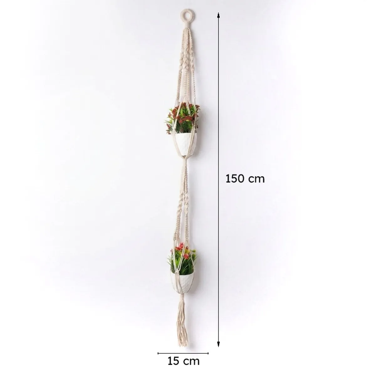 White macrame planter shown hanging with two plant holders