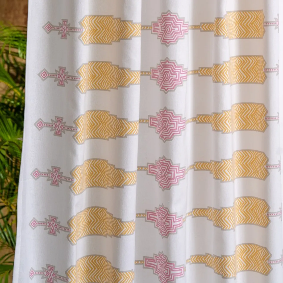 Detailed view of pink and yellow geometric curtain pattern
