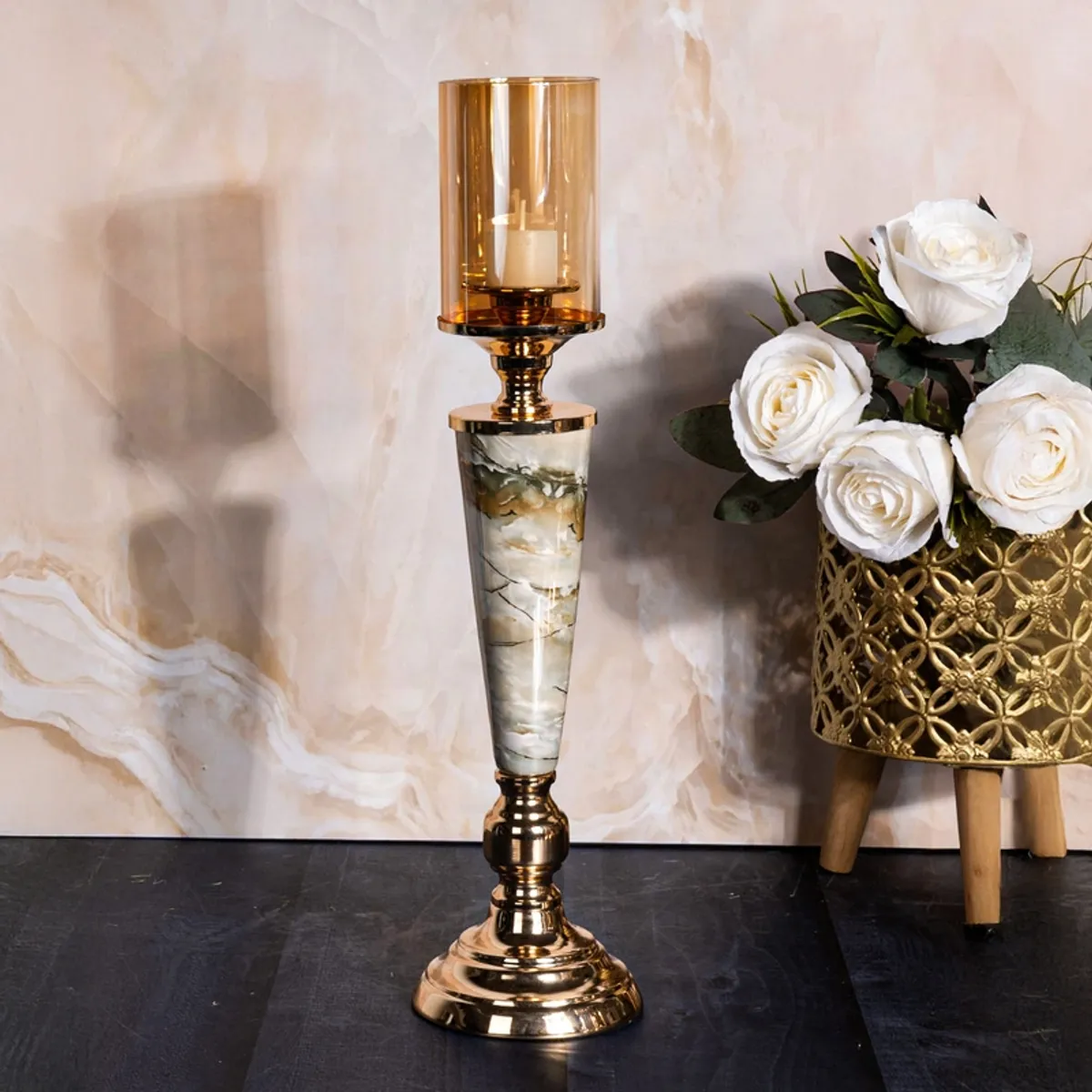 Gold and white marble candle holder with a clear glass shade and candle