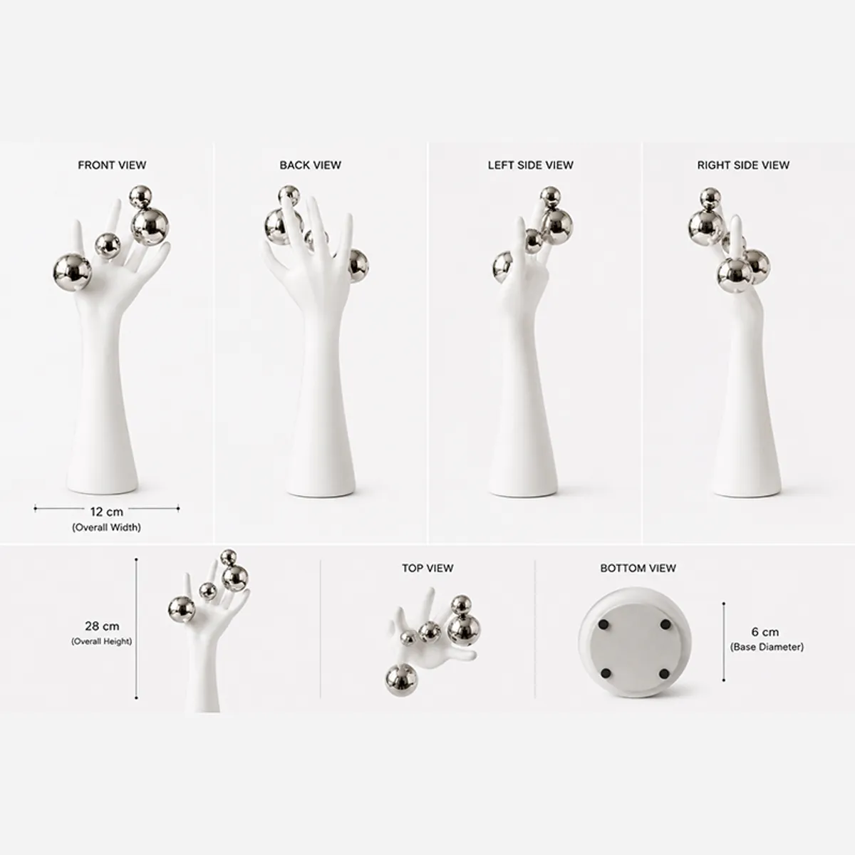 Multiple views of a white hand sculpture with silver spheres against a plain background