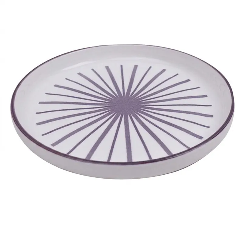Single white snack plate with purple starburst pattern on white background