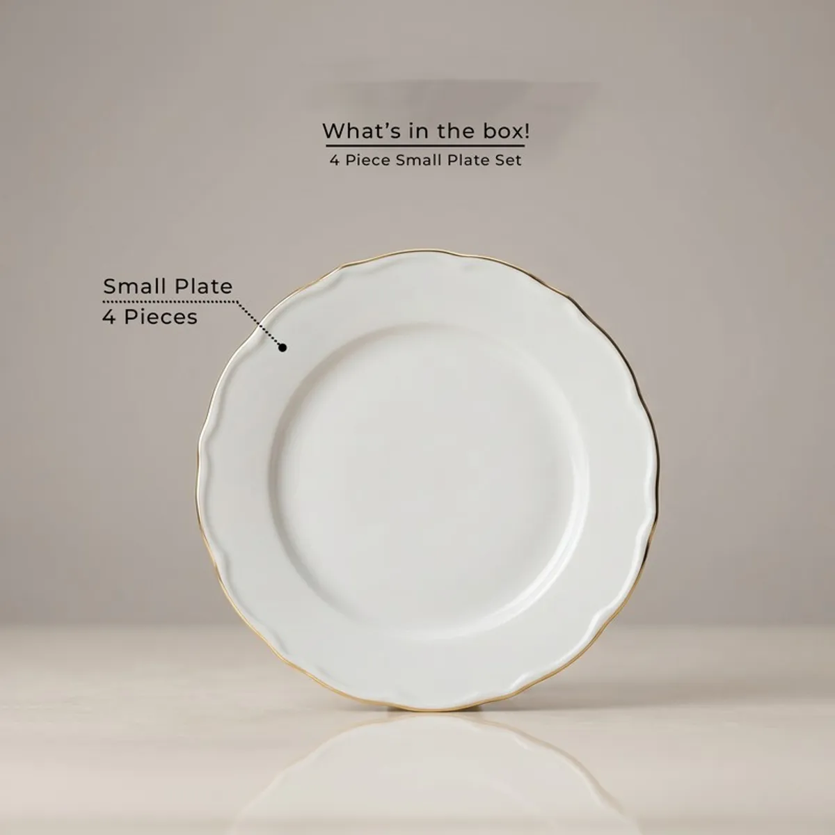 Single white scalloped plate with gold rim shown front on