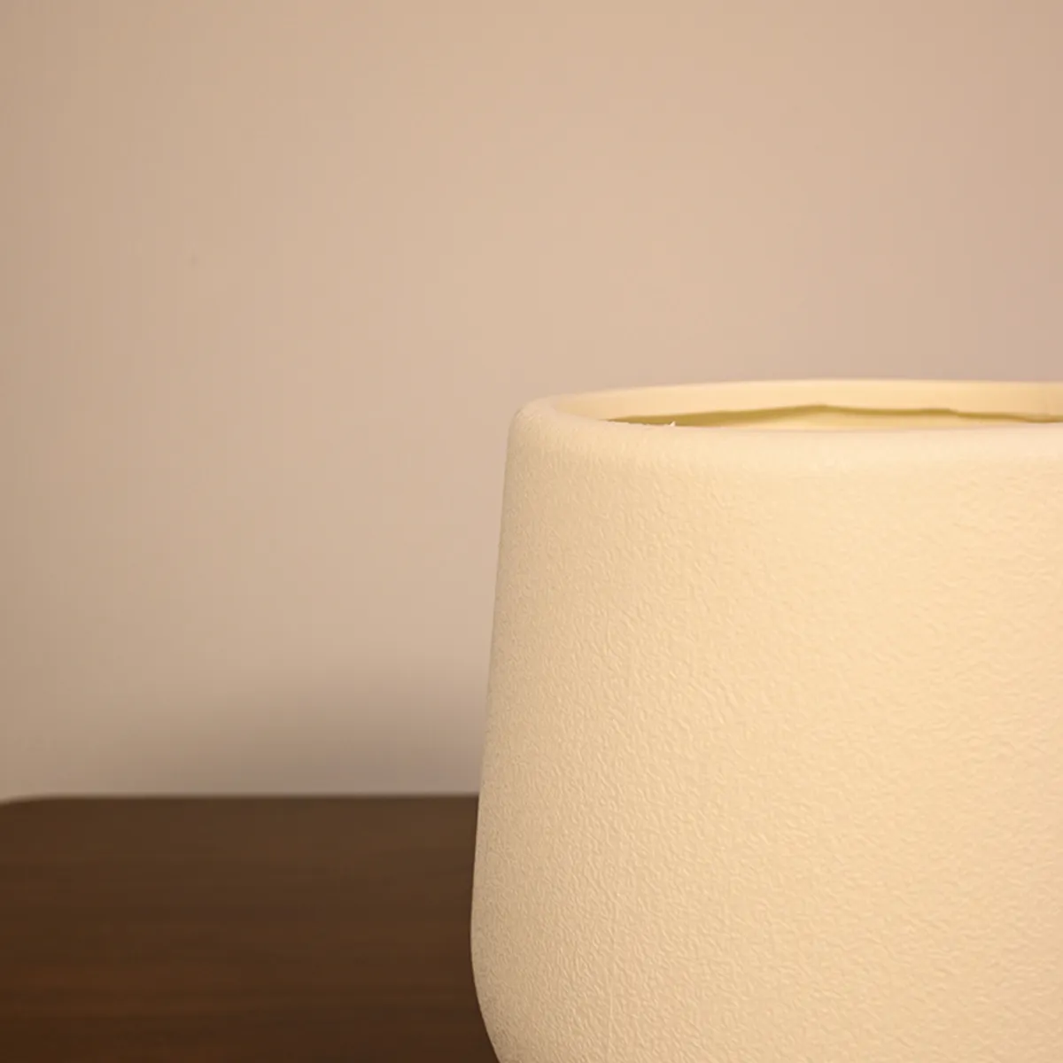 Close-up side view showing the matte textured finish of a white planter