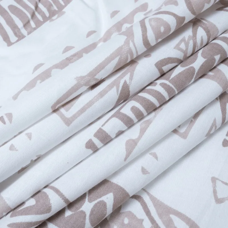 Folded white fabric with soft brown abstract printed pattern