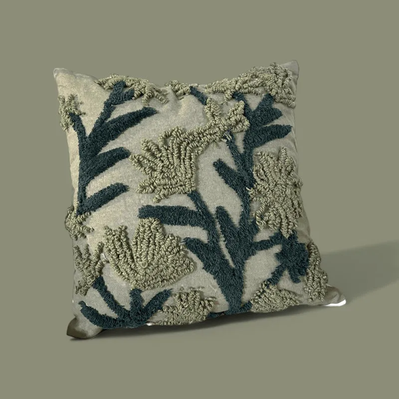 Green tufted floral cushion cover against a muted olive background