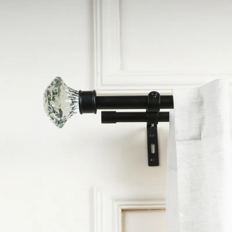 Double black curtain rod with clear faceted finial and white curtain