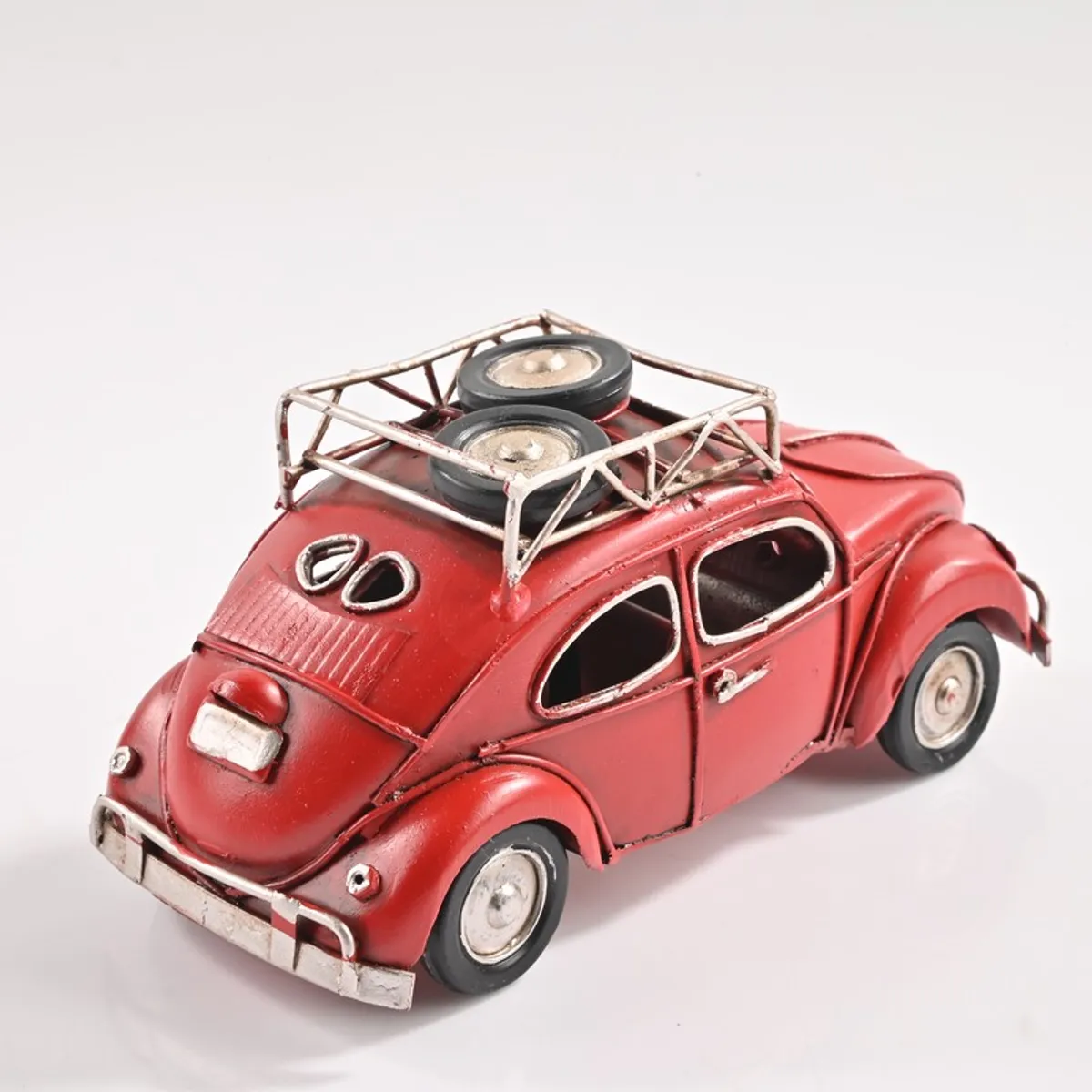 Rear angled view of red vintage car metal showpiece