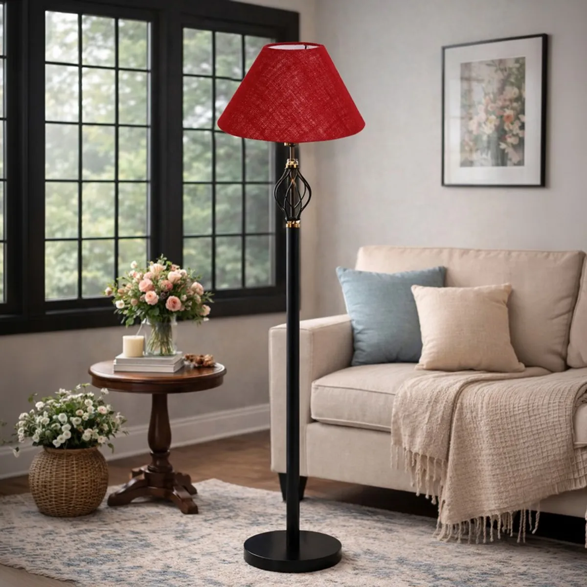 Red floor lamp with black stand styled near a sofa, round table and large window.
