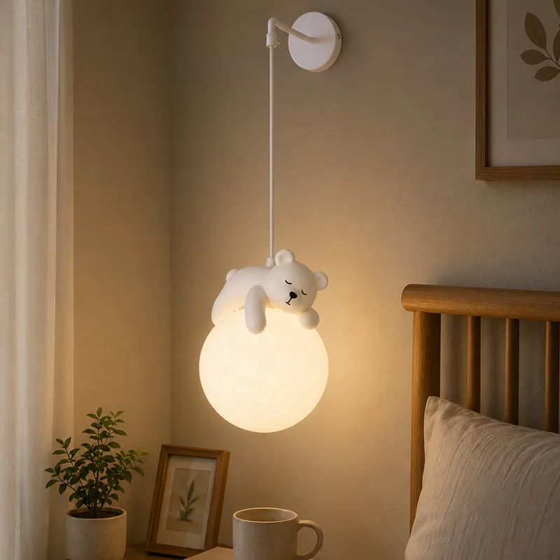 Sleepy bear wall lamp mounted beside a bed with a softly glowing globe
