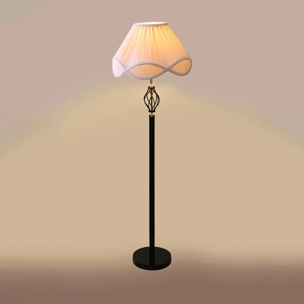 Lit floor lamp with pale pink shade against a plain background
