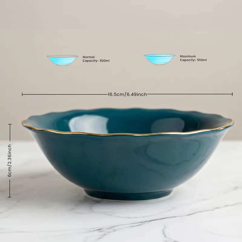 Close view of a dark teal serving bowl with gold rim