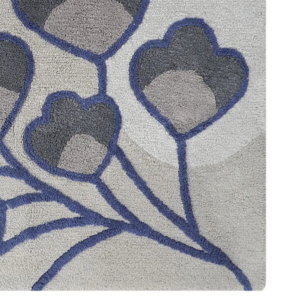 Close-up of the bath mat's textured grey and blue floral surface