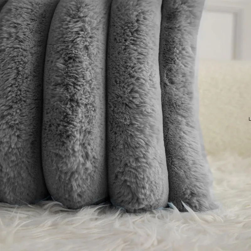 Close-up of the soft, tufted faux-fur texture on a grey cushion cover