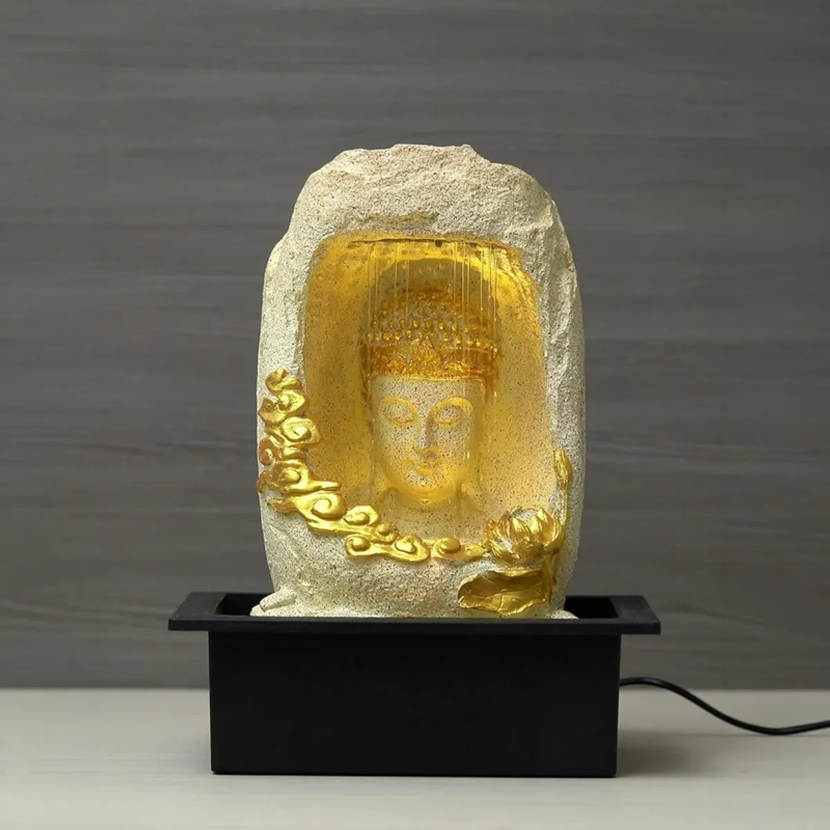 Front view of the ivory Buddha flow fountain with warm LED glow