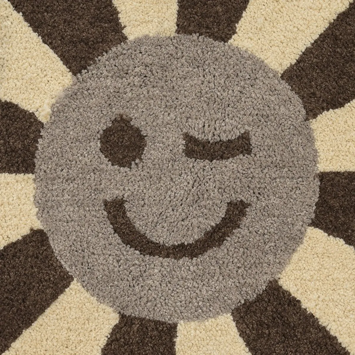 Close-up of the textured grey smiling centre and brown floral details