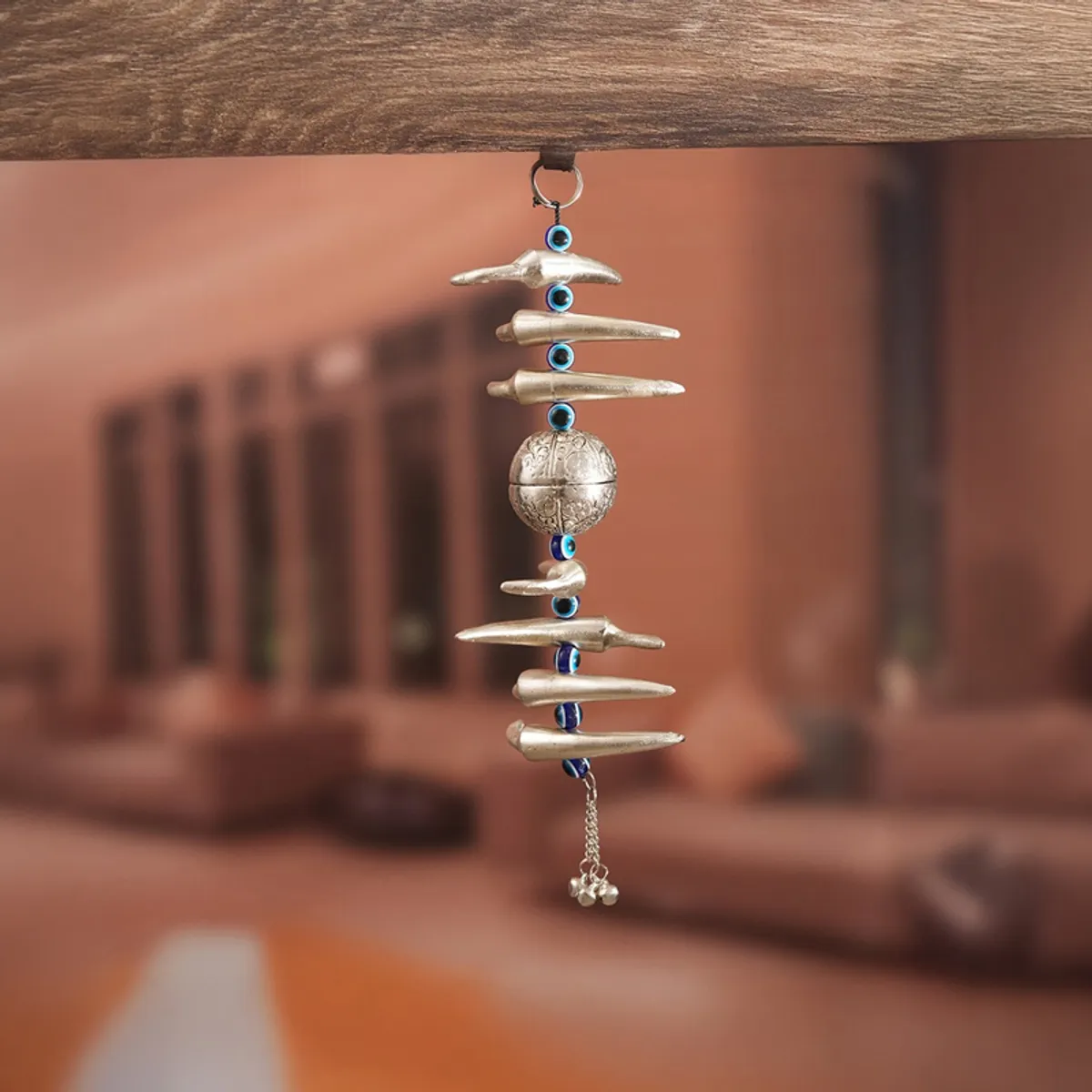 Silver hanging décor suspended beneath a wooden surface