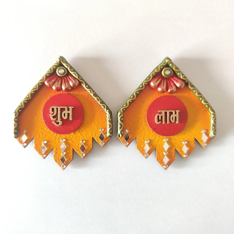Close view of two orange Shubh and Laabh wall accents