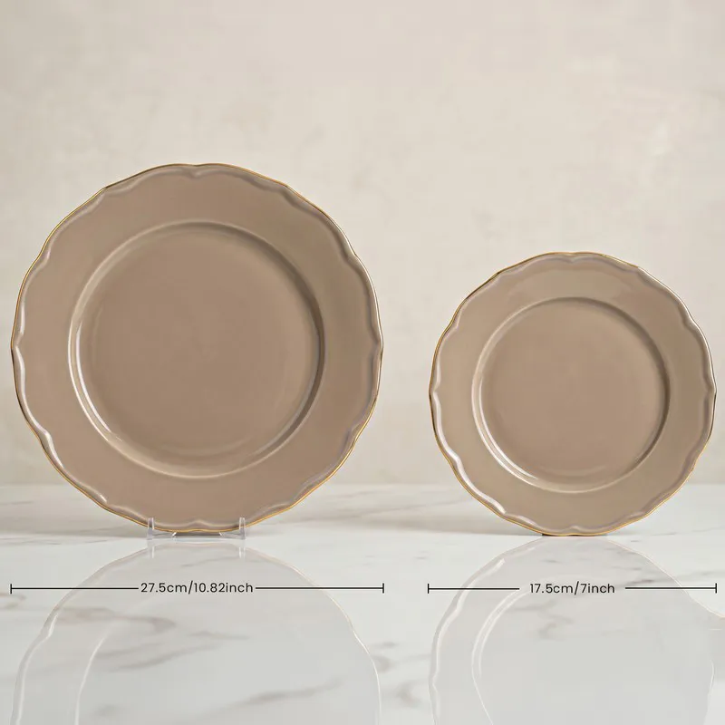 Large and small grey plates with gold rims on stands
