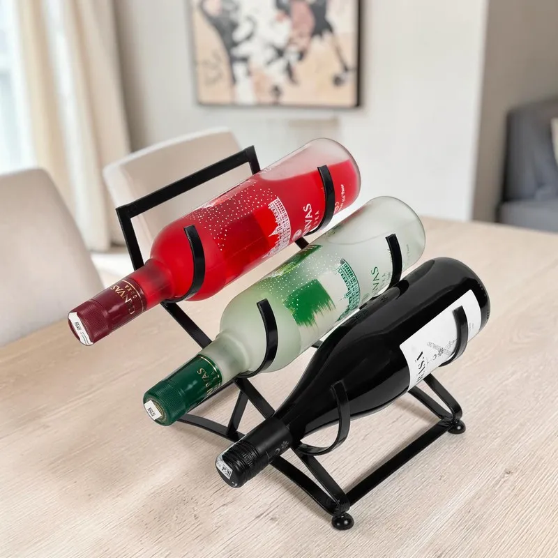Black iron bottle holder with three bottles styled on a dining table.