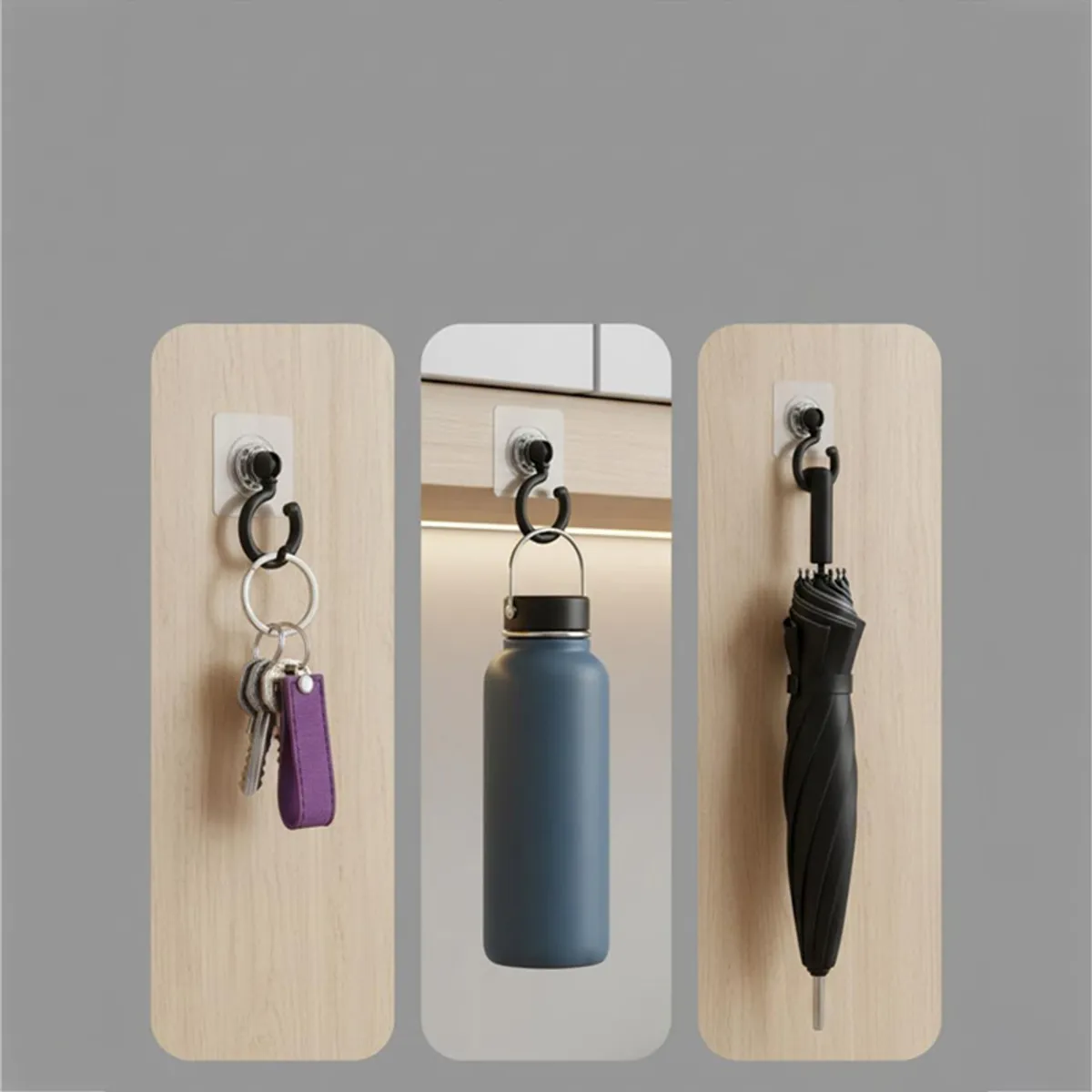 Black wall hooks shown holding keys, a bottle and an umbrella