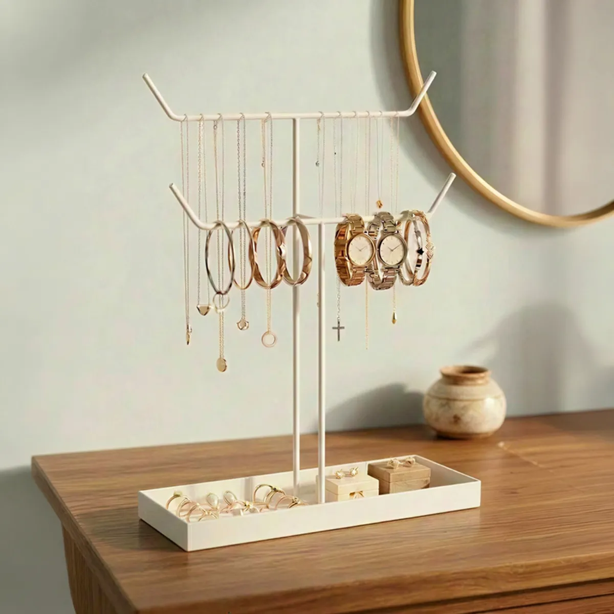 White metal jewellery stand displaying necklaces, bangles, watches and earrings
