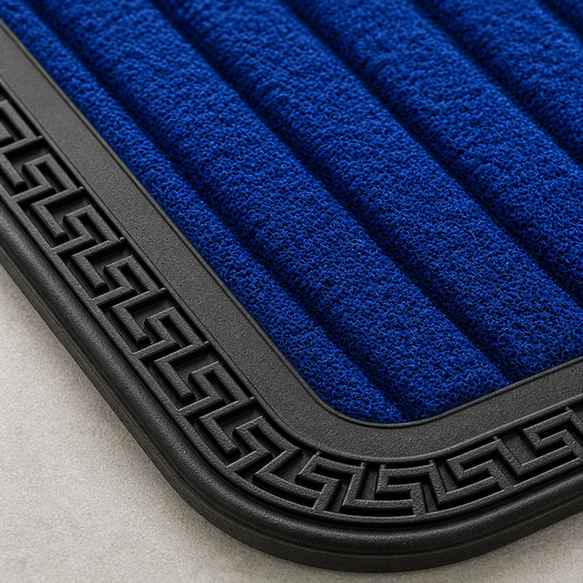 Close-up of blue ribbed mat surface and black geometric border
